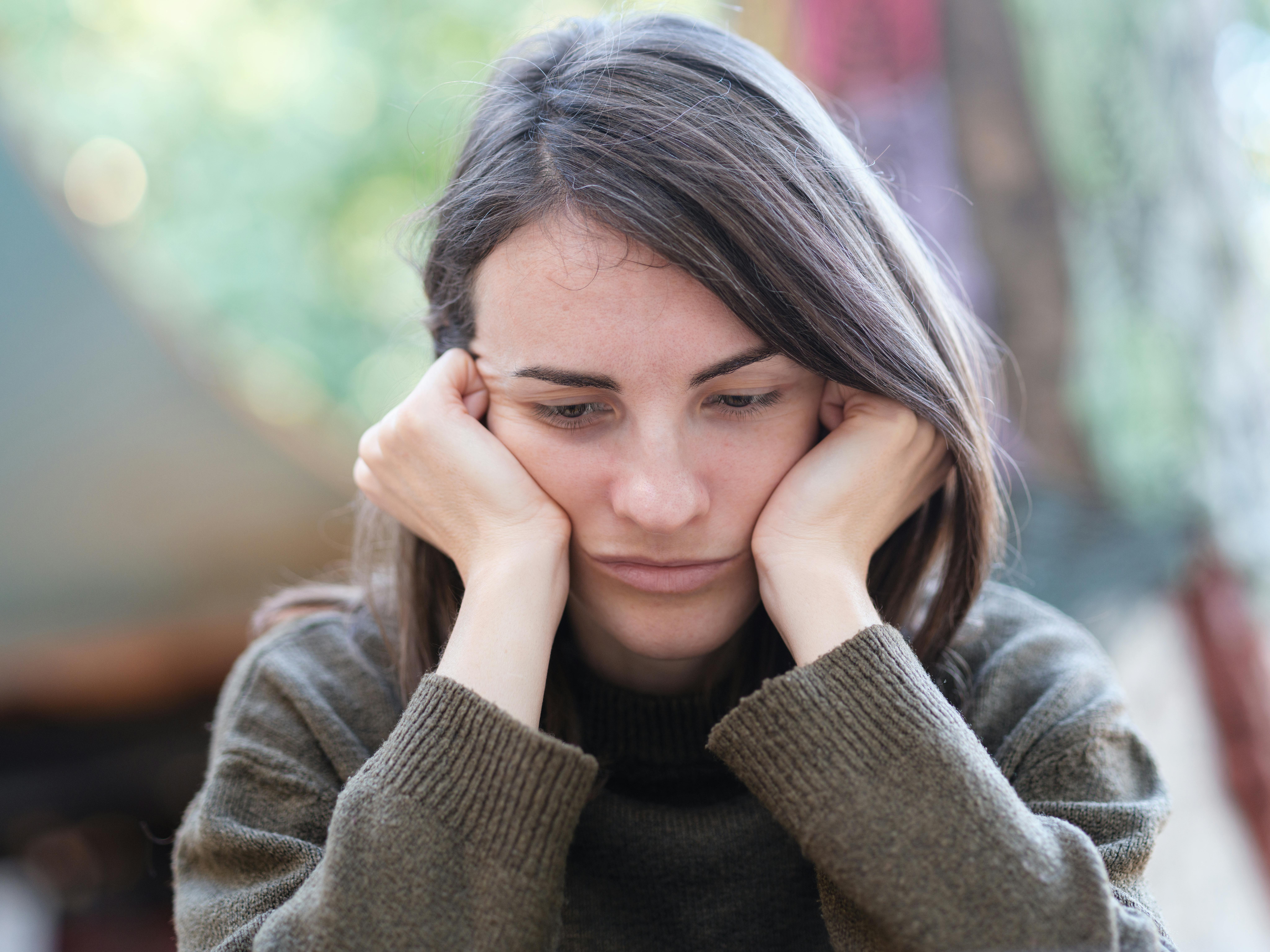 Young woman feeling anxious about telling her parents about an unplanned pregnancy.